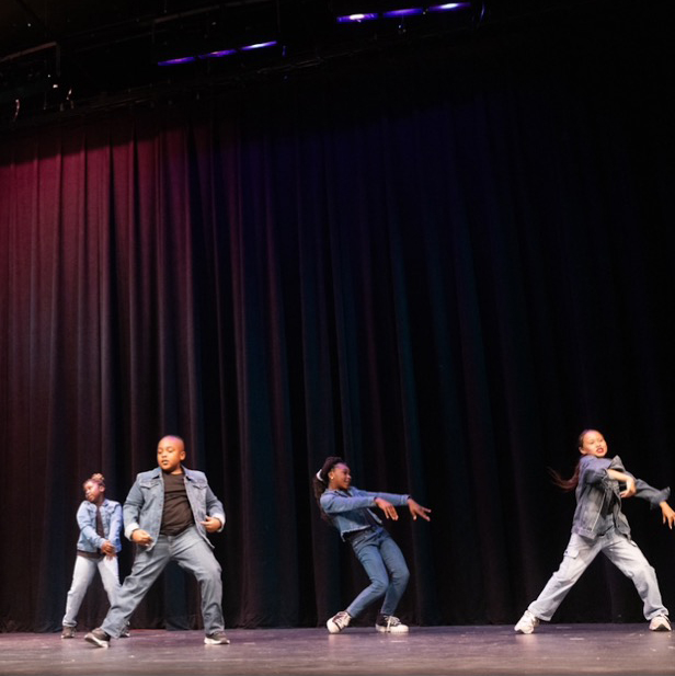 Four hip hop dancers on stage.