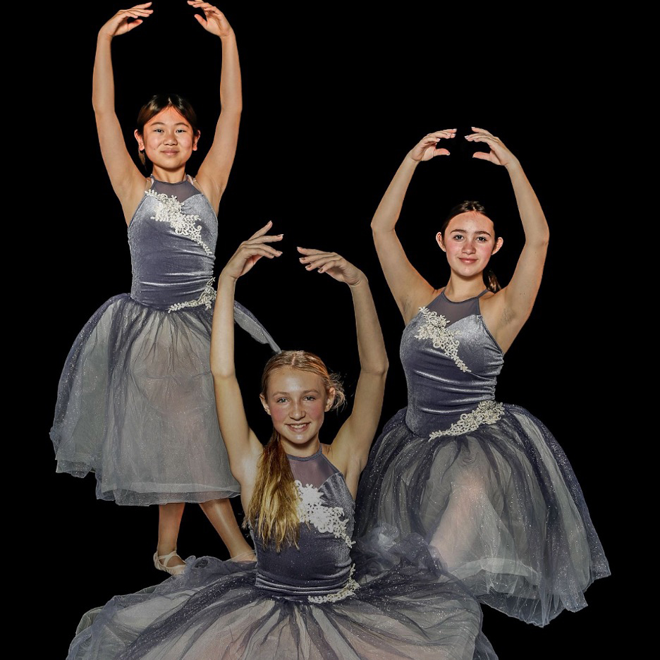 three ballet dancers posing at recital